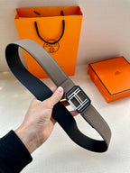 Gray leather belt with wide strap and silver-tone H buckle