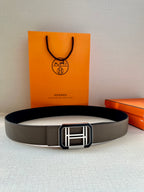 Gray leather belt with wide strap and silver-tone H buckle