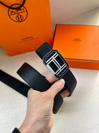 Dark blue leather belt with silver geometric buckle, side view
