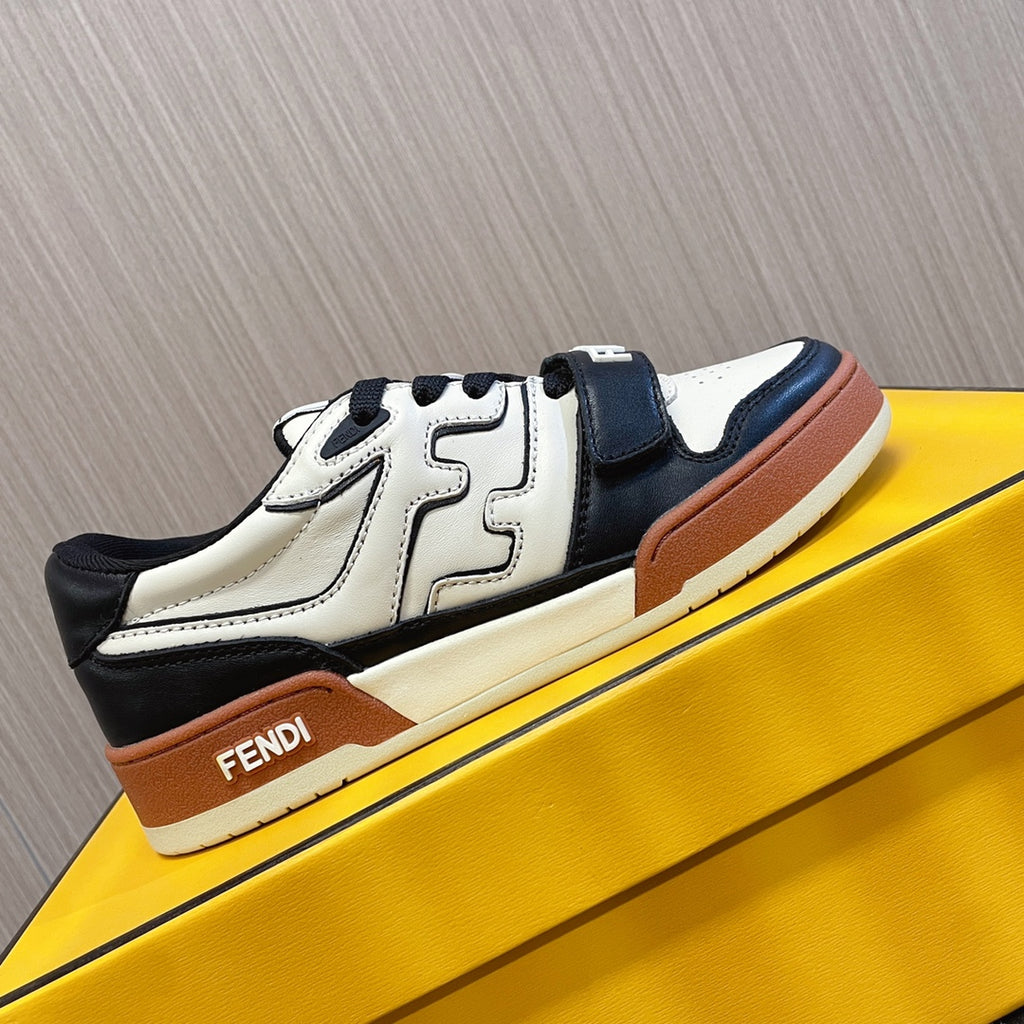 Fendi unisex sneakers on display with white leather, black side panel, tan sole trim