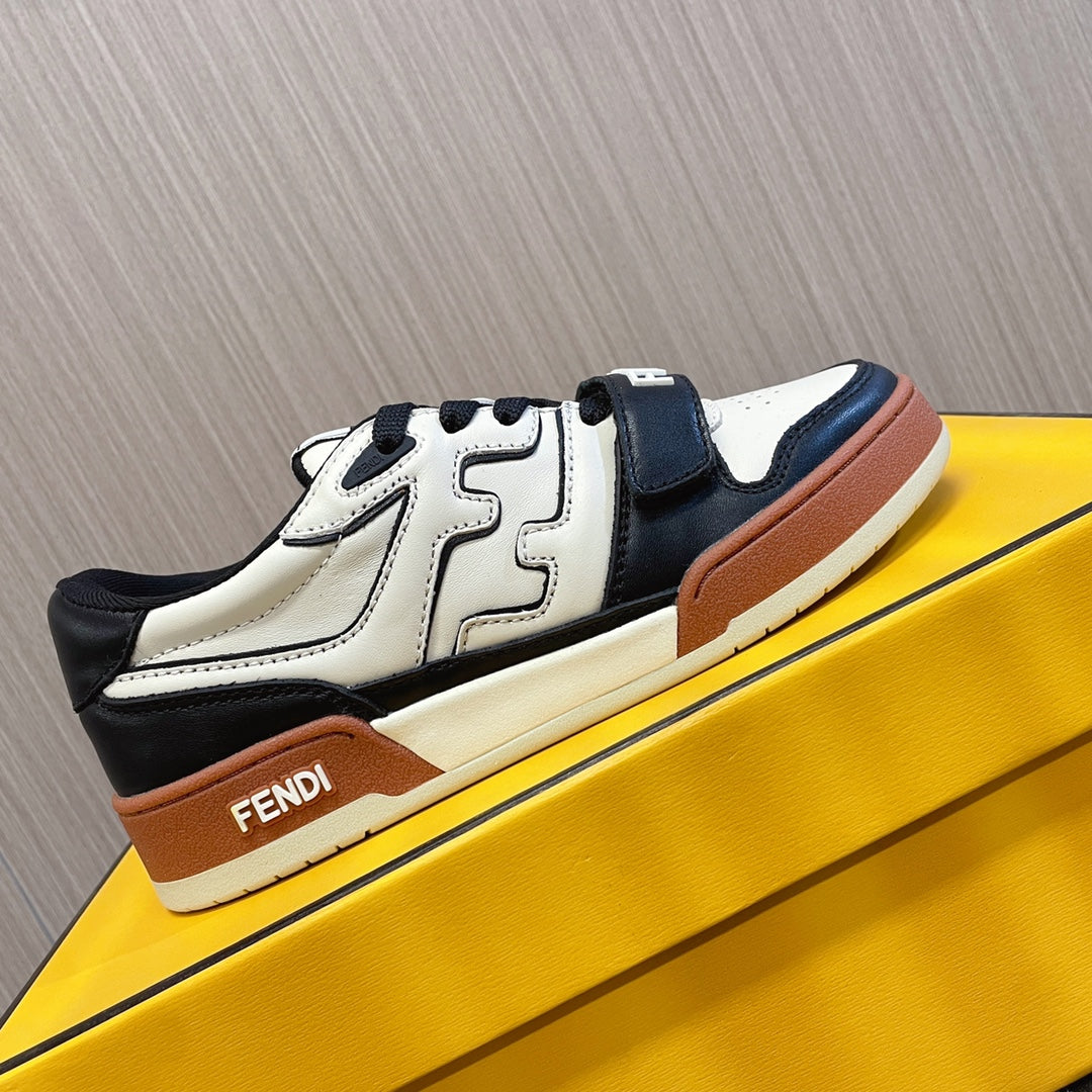 Fendi unisex sneakers on display with white leather, black side panel, tan sole trim