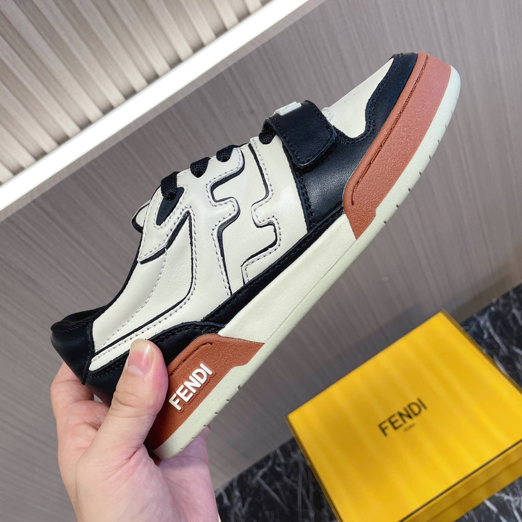 Fendi unisex sneaker close-up, white and black uppers with tan Fendi logo detail
