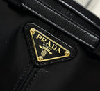 Black leather patch with gold Prada logo and detailed stitching