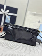 Black leather clutch-style bag with gold-tone buckle strap and front logo plaque