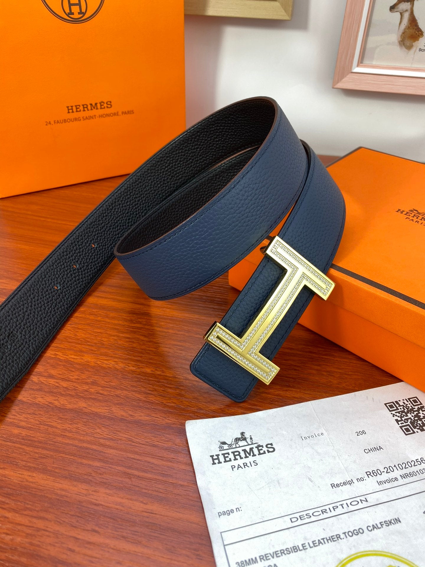Blue leather belt with textured strap and gold-tone H buckle