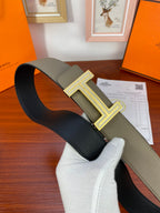 Hermes reversible belt shown folded: dark inner strap with light olive outer strap