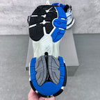 Unisex sneakers outsole view with black tread and blue rubber sections