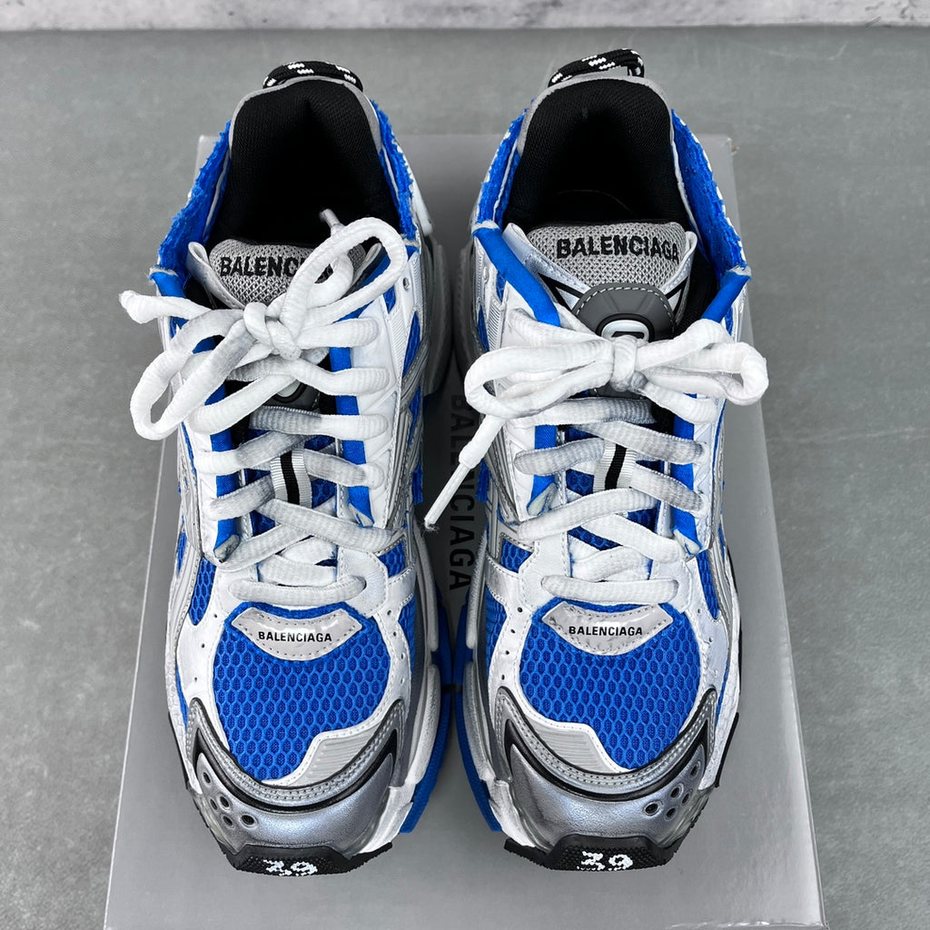 Unisex sneakers pair on box, black lining, white laces, blue toe panels