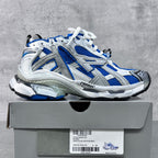 Unisex sneakers in white and blue on shoe box, lace-up athletic style
