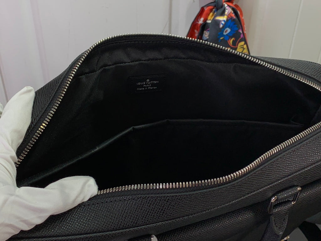 Open men's Louis Vuitton briefcase interior with zip opening and side wall