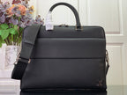Louis Vuitton handbag with top handle, flap front, and adjustable shoulder strap, dark