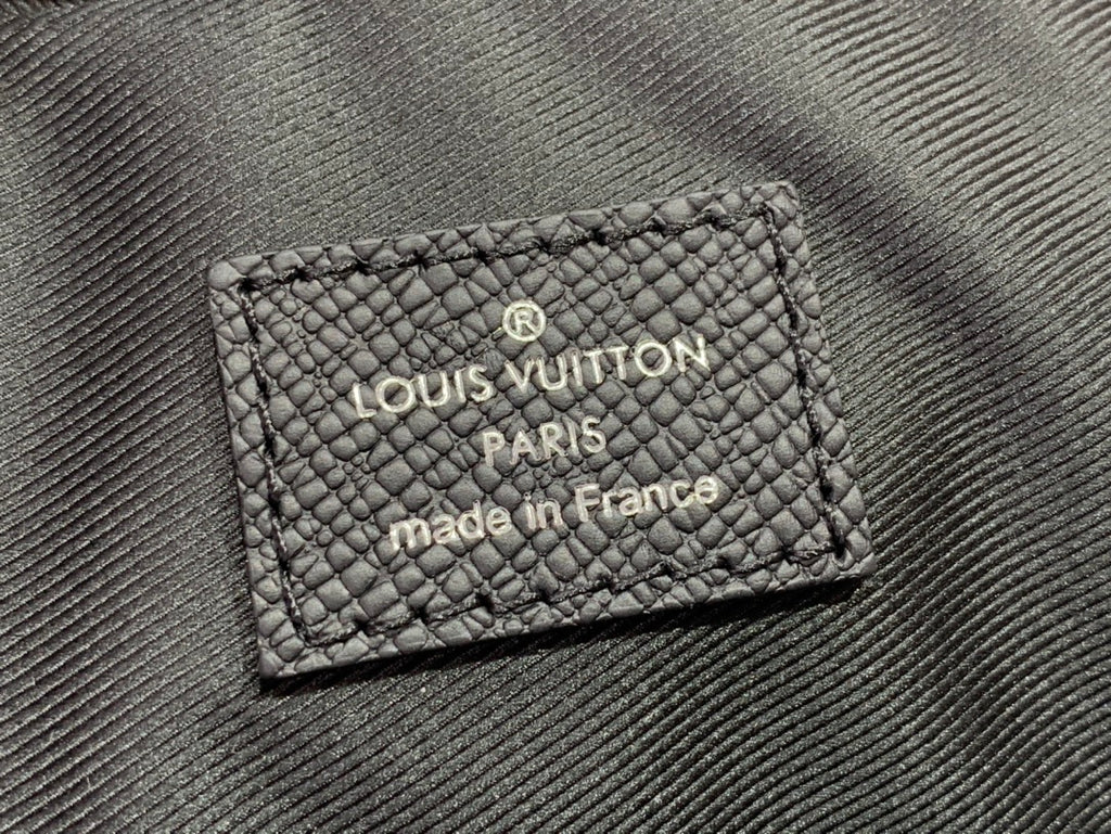 Black leather handbag label reading LOUIS VUITTON PARIS made in France
