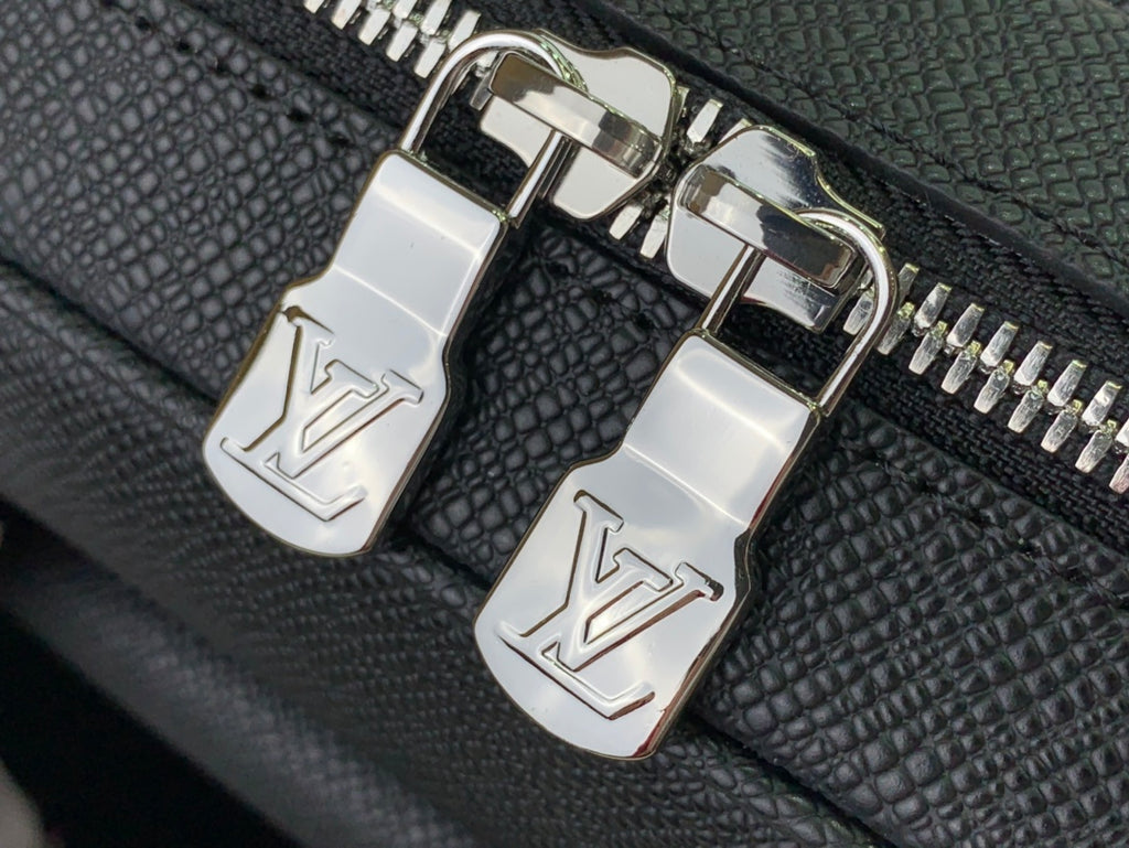 Louis Vuitton LV zipper pulls on textured bag with gold-tone zipper