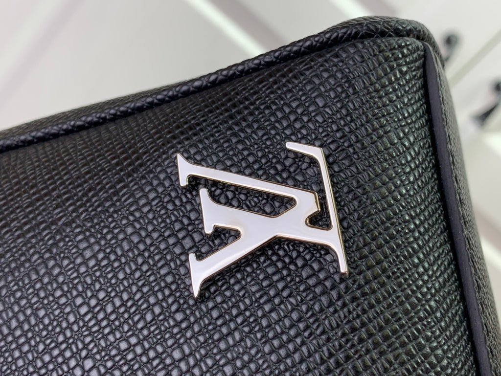 Louis Vuitton logo plaque on textured leather-look bag panel