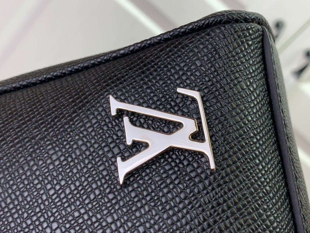 Louis Vuitton logo plaque on textured leather-look bag panel
