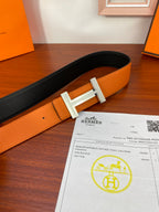 Reversible leather belt with black strap and orange side, silver H buckle