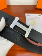Black textured leather belt with silver H buckle close-up
