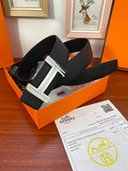 Black textured leather belt with silver H buckle in orange gift box