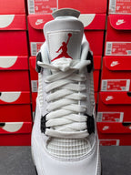 White high-top sneaker with red Jumpman logo on the heel and white laces