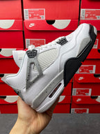 White leather high-top sneaker with black lace guard and visible air unit