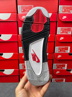 Black and gray outsole with red triangular traction pattern