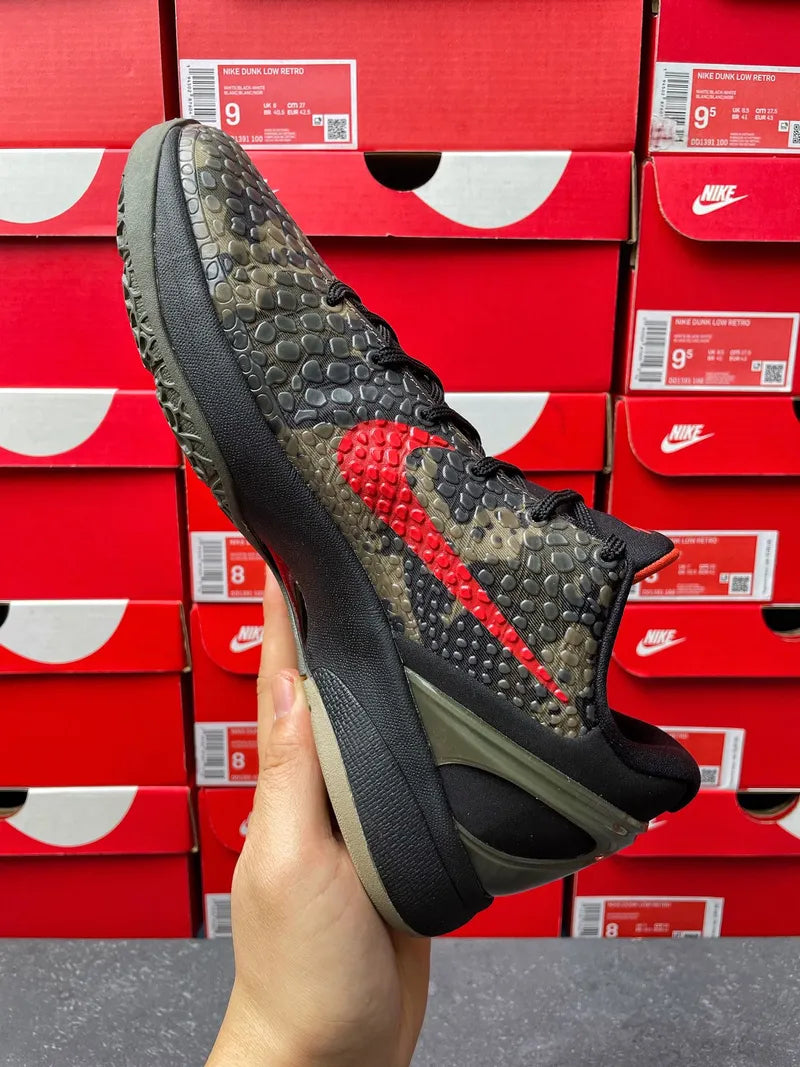 Mens basketball shoe diagonal side view, black camo upper with red swoosh and olive trim