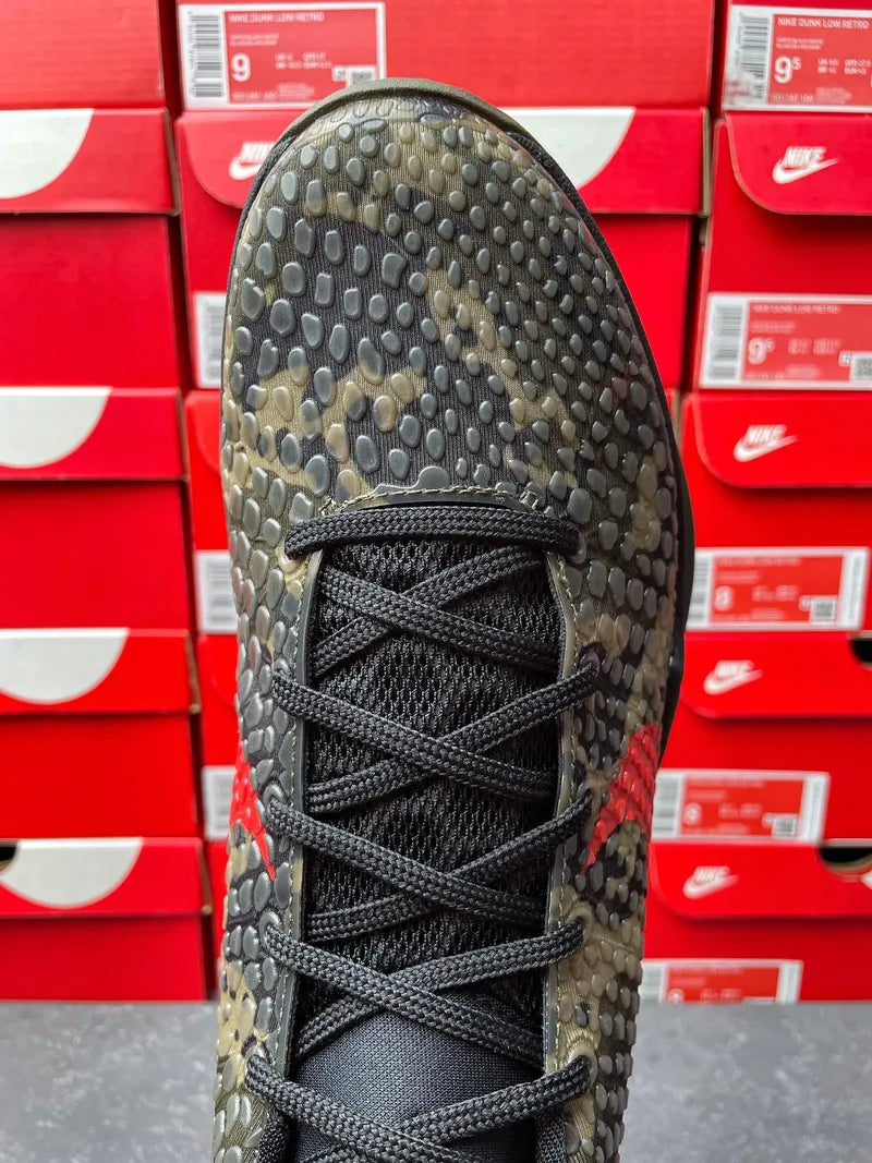 Mens basketball shoe lace-up front view, dark camo upper with red swoosh detail
