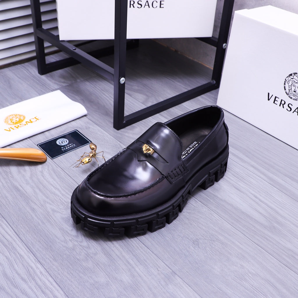 Black Versace leather loafer with gold emblem detail and thick tread sole, side view