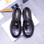 Black Versace leather loafers with gold emblem and chunky lug sole, pair front view