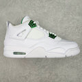 White low-top sneaker with green lace accents and Air sole window