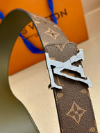 Louis Vuitton monogram canvas belt close-up with silver-tone buckle and dark green lining