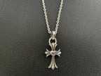 Silver-tone cross pendant necklace with flower-like centerpiece and open bail loop