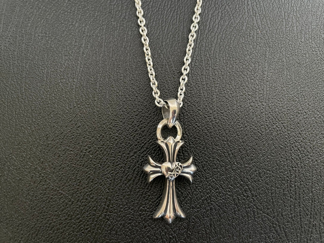 Silver-tone cross pendant necklace with flower-like centerpiece and open bail loop