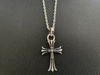Silver-tone cross pendant necklace with long vertical center and flared arm tips