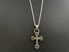 Silver-tone cross pendant necklace with ornate central detail and chain links