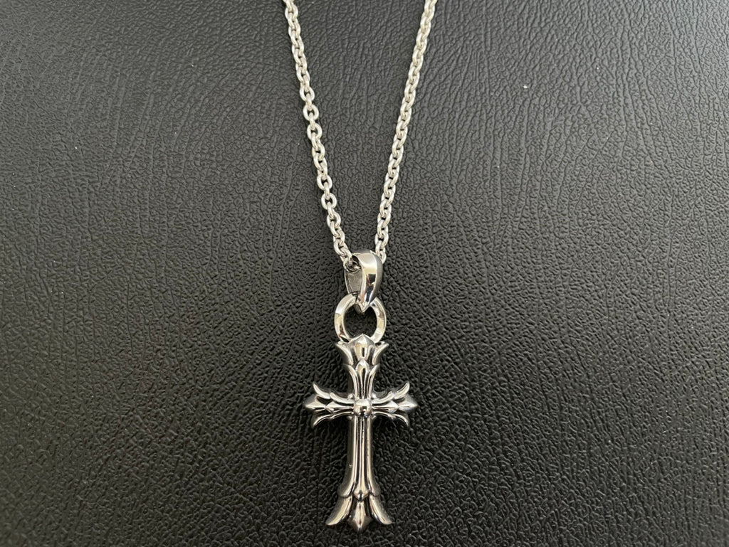 Silver-tone cross pendant necklace with rounded top bail and detailed crosswork