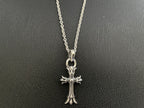 Silver-tone cross pendant necklace with rounded top bail and detailed crosswork