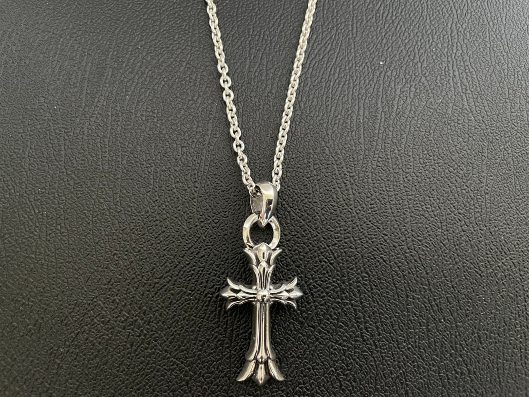 Silver-tone cross pendant necklace with rounded top bail and detailed crosswork