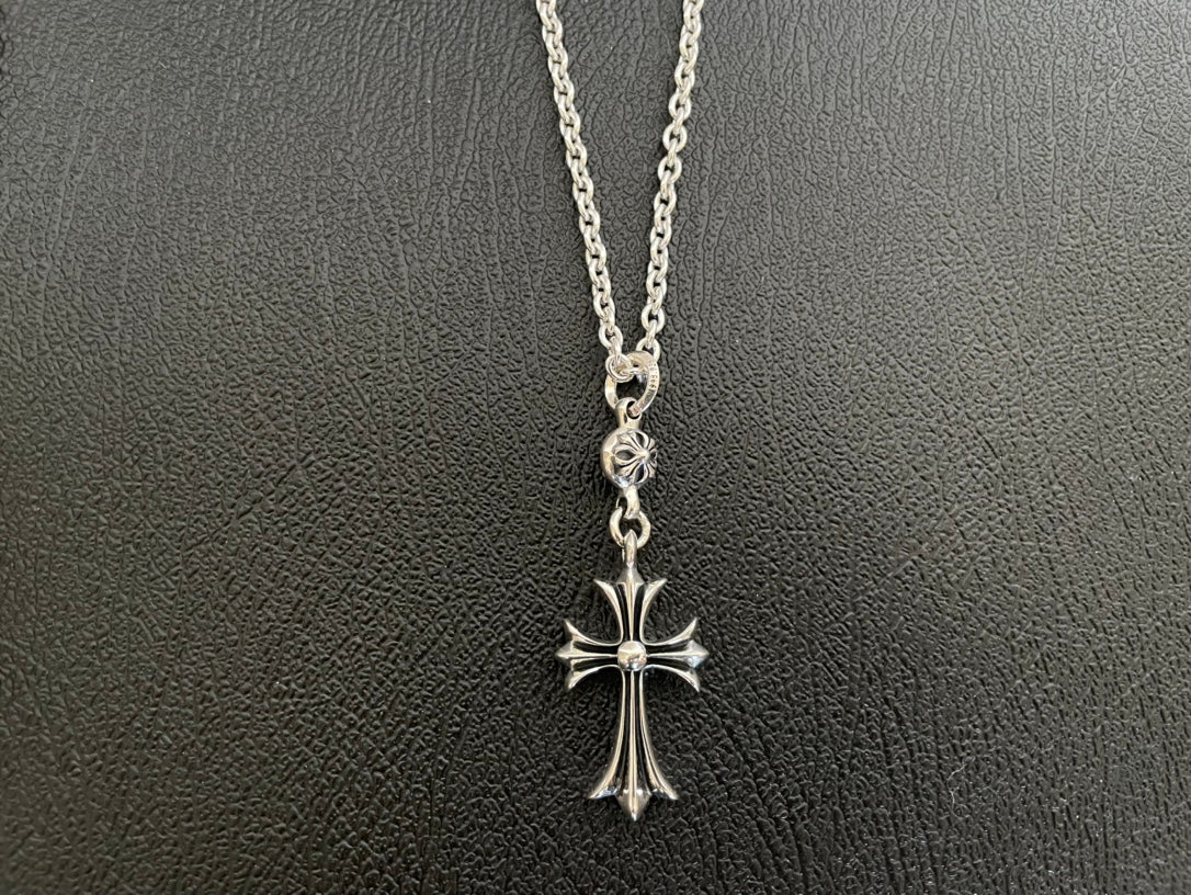 Silver-tone cross pendant necklace with open loop clasp and flared cross arms