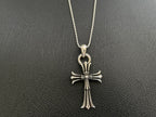 Chrome-tone chain necklace with detailed cross pendant