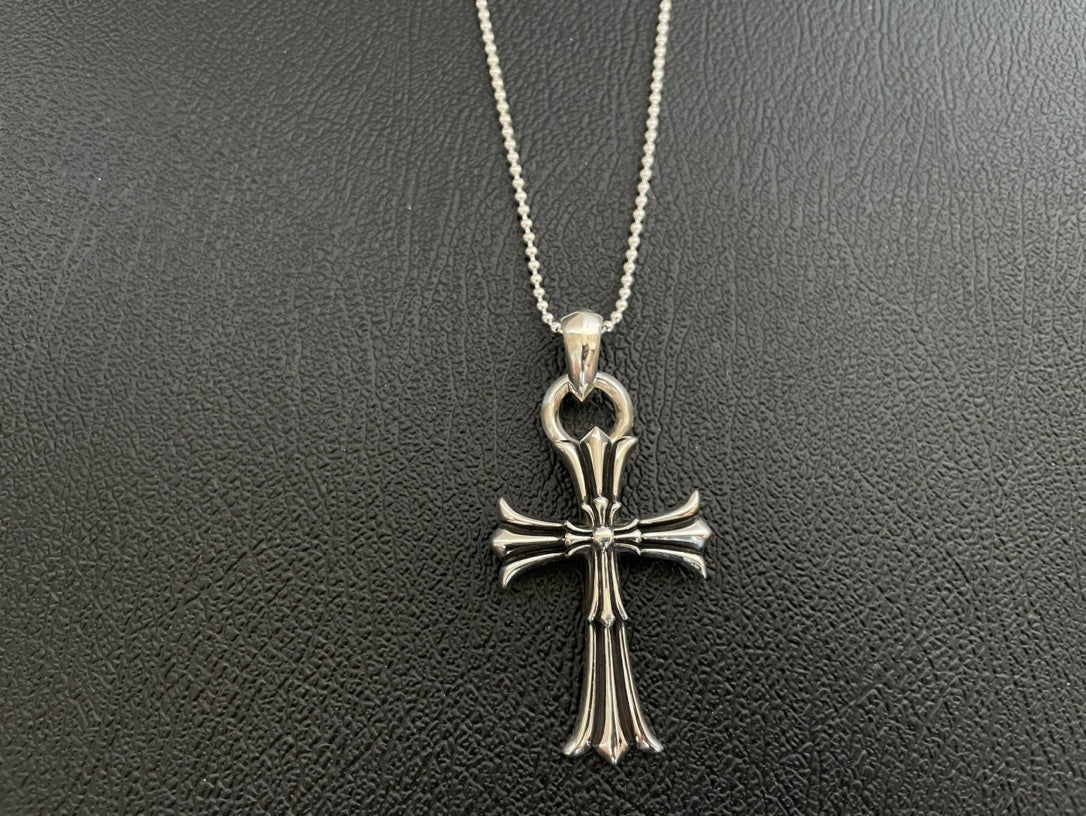 Chrome-tone chain necklace with detailed cross pendant