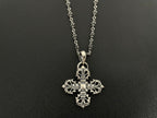 Silver-tone ornate cross charm necklace with scroll details on double chain.