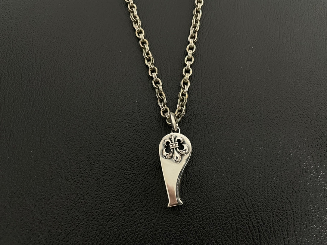 Silver-tone heart-shaped charm necklace with engraved face design on double chain.