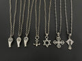 Silver-tone charm necklaces set with assorted pendants on chain, including fleur-de-lis and star.