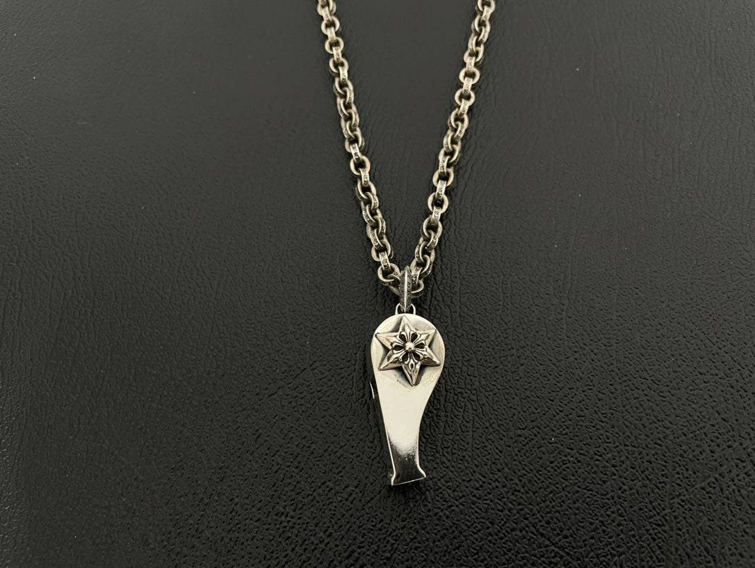 Silver-tone pointed charm necklace with starburst cutout on double chain.