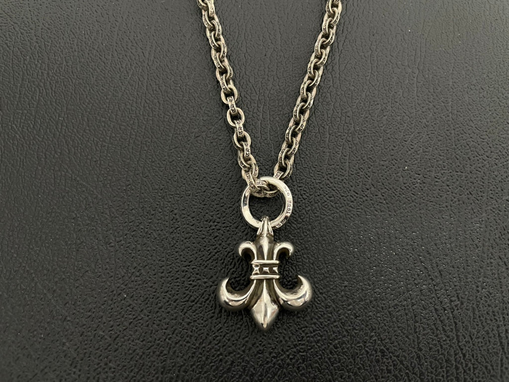 Silver-tone anchor charm necklace with crowned anchor pendant on double chain.