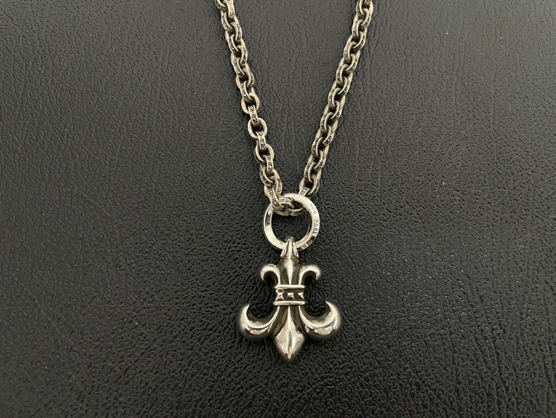 Silver-tone anchor charm necklace with crowned anchor pendant on double chain.