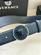 Versace dark blue leather belt close-up of round Medusa buckle and strap texture