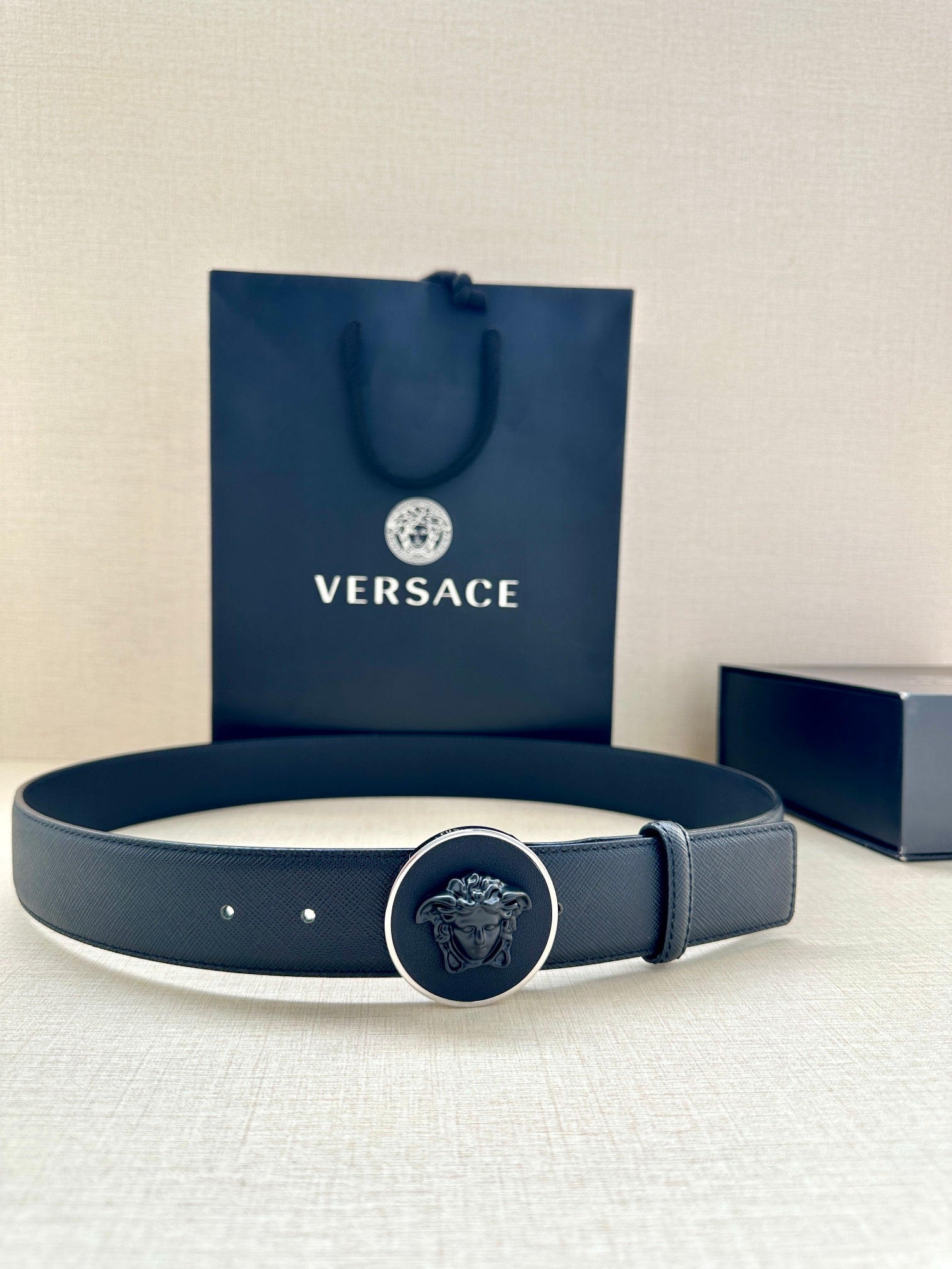 Versace dark blue leather belt with round Medusa buckle on band and belt holes