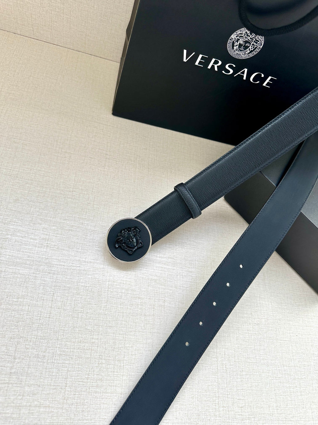 Versace belt with round emblem buckle and dark blue strap detail